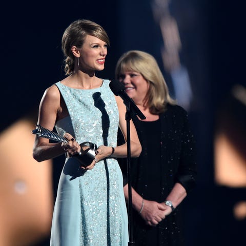 Taylor Swift (L) accepts the 50th Anniversary Mile