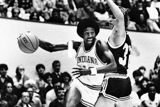 Indiana University's Mike Woodson drives around Washington's Stan Walker during the championship game of the Indiana Classic in Bloomington, December 19, 1978.