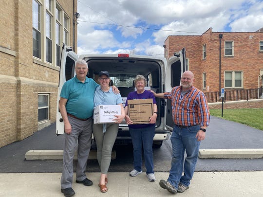 (L-R) Volunteers Jim Anderson, Audrey Glass, Lynn Anderson, and Joe Holbrook from Bottoms Up, pose with diapers and wipes they collected outside of St Peter's Catholic Church in Chillicothe.