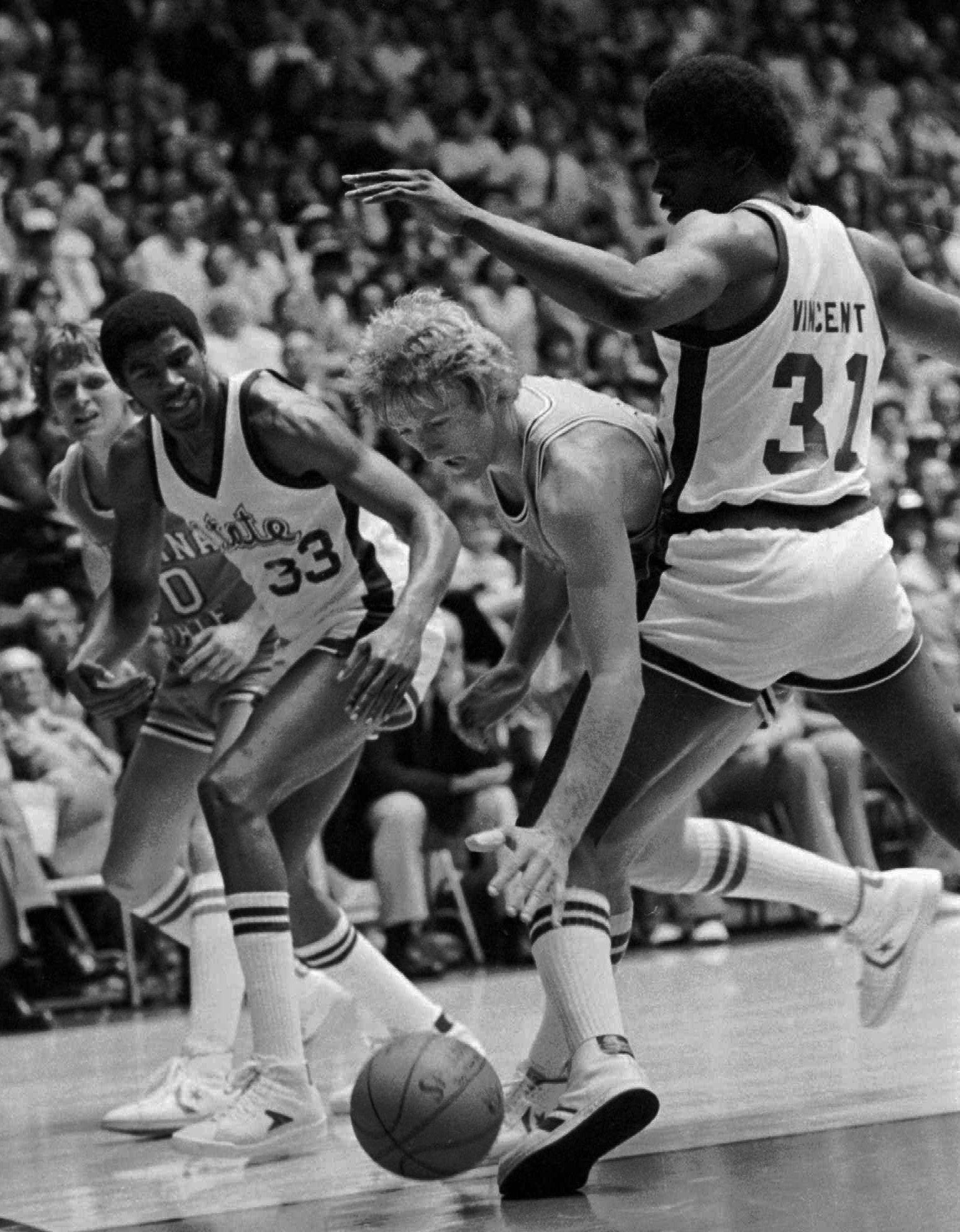 Michigan State's Jay Vincent (31) and Earvin Johnson apply pressure as Indiana State's Larry Bird looks for help during their NCAA championship game in 1979.