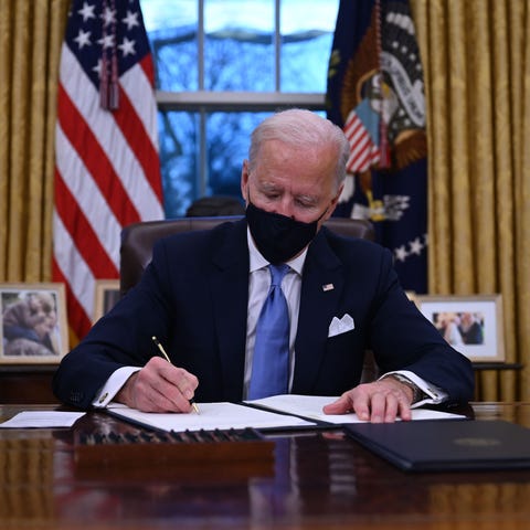 US President Joe Biden sits in the Oval Office as 