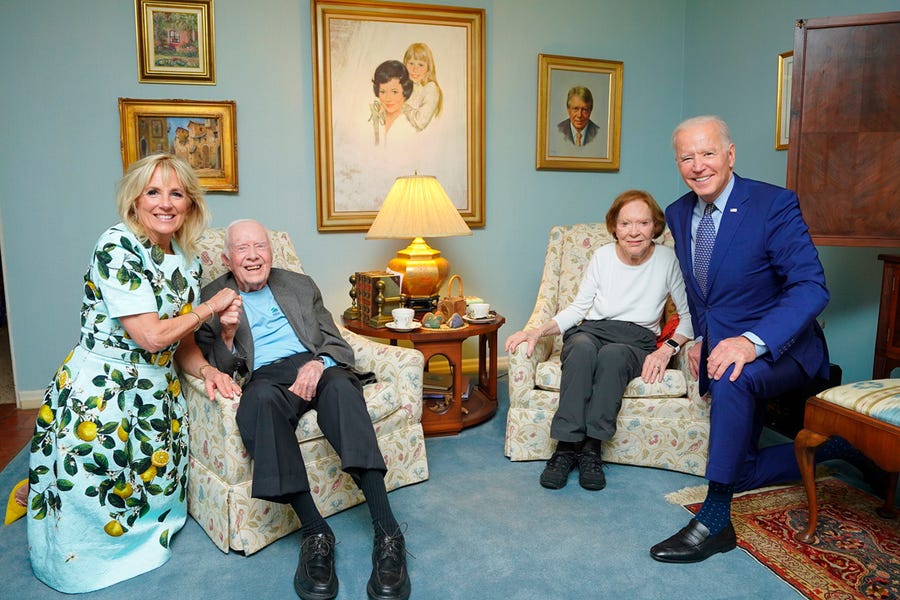 In this April 30, 2021, photo released by The White House, former President Jimmy Carter and former first lady Rosalynn Carter pose for a photo with President Joe Biden and first lady Jill Biden at the home of the Carter's in Plains Ga.