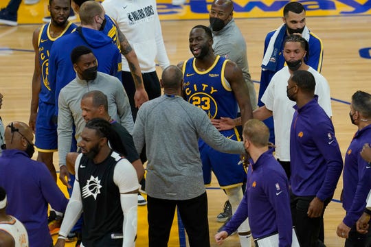 Golden State Warriors forward Draymond Green (23) talks toward Phoenix Suns players during halftime of an NBA basketball game in San Francisco, Tuesday, May 11, 2021. (AP Photo/Jeff Chiu).