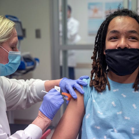 Marquis Granton smiles as RN Mary VanPelt administ