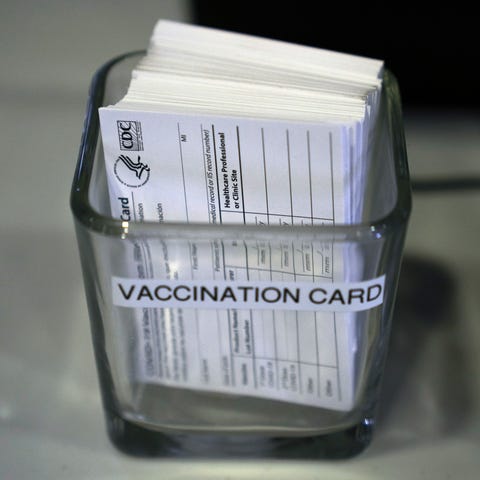 COVID-19 vaccination cards are displayed on a chec