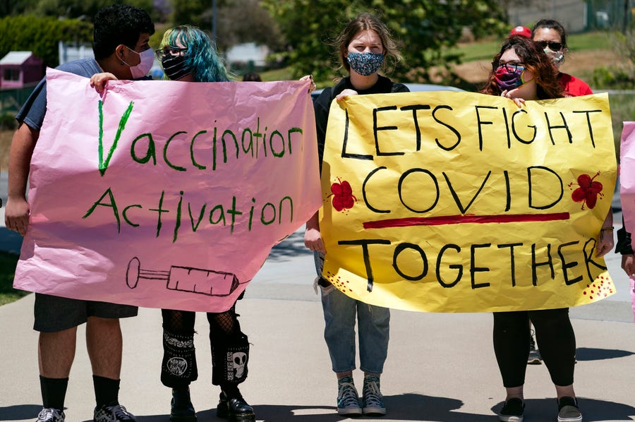 San Pedro High School students promote vaccination May 24 at a school-based event for students 12 years and older in San Pedro, Calif. Schools turn to mascots, prizes and contests to entice eligible students to get vaccinated against the coronavirus before the summer break.