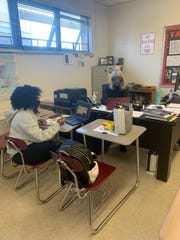 Tate High School yearbook editor-in-chief Samantha Guerrier works with yearbook sponsor Gail Atkins. Guerrier was suspended after a horse mascot sticker was placed over the face of expelled homecoming queen Emily Grover.