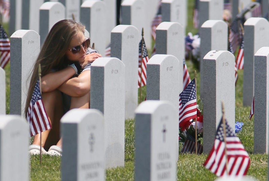 Elizabeth Spence of Cleveland visits the grave of her grandfather Edward Spence U.S. Army World War II veteran at Ohio Western Reserve National Cemetery on Monday May 31, 2021. Spence said her grandfather, who died in 2019, was like a father to her.    