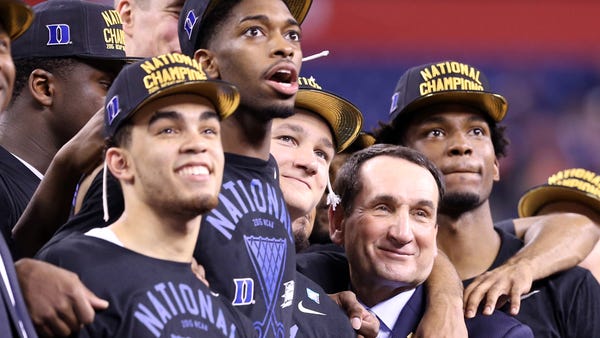 Mike Krzyzewski celebrates with members of Duke's 