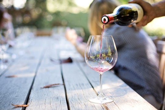 A glass of wine being poured