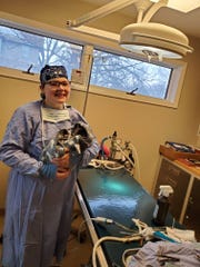 Hartland native Tessa Brown holds her cat, Dinah, after spaying her in veterinary school.