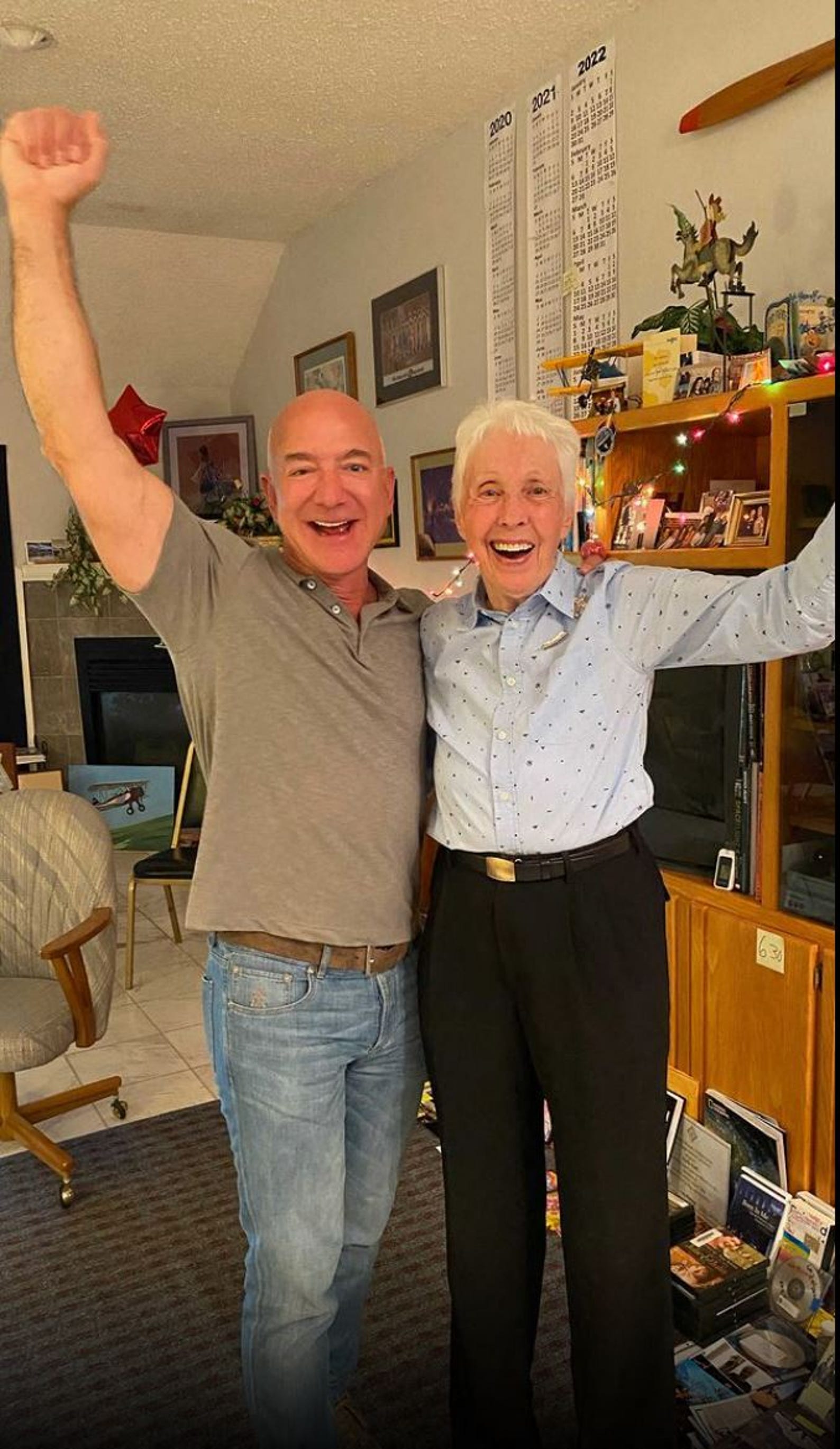 This image posted on Jeff Bezos Instagram account (@jeffbezos) and on the Blue Origin website on July 1st, 2021 shows the moment when Amazon and Blue Origin founder Jeff Bezos (L) announces to Wally Funk (R) she will fly to Space with him on the Blue Origin's New Sheppard first human flight. - Wally Funk, a 82-year-old woman pilot, will join Jeff Bezos in traveling to space this month on the first crewed spaceflight for the billionaire's company Blue Origin, the firm announced Thursday. Funk will become the oldest person ever to fly to space when she takes part in the July 20 journey aboard the New Shepard launch vehicle along with Bezos, his brother Mark and the unnamed winner of an auction for another seat on the aircraft. (Photo by - / BLUE ORIGIN / AFP) / RESTRICTED TO EDITORIAL USE - MANDATORY CREDIT "AFP PHOTO /BLUE ORIGIN" - NO MARKETING - NO ADVERTISING CAMPAIGNS - DISTRIBUTED AS A SERVICE TO CLIENTS (Photo by -/BLUE ORIGIN/AFP via Getty Images)