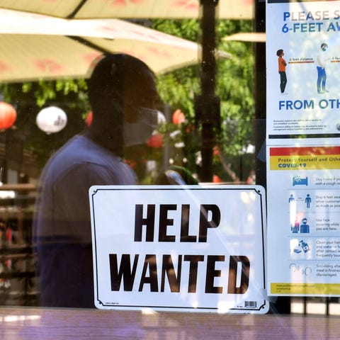 A "Help wanted" sign is posted beside coronavirus 