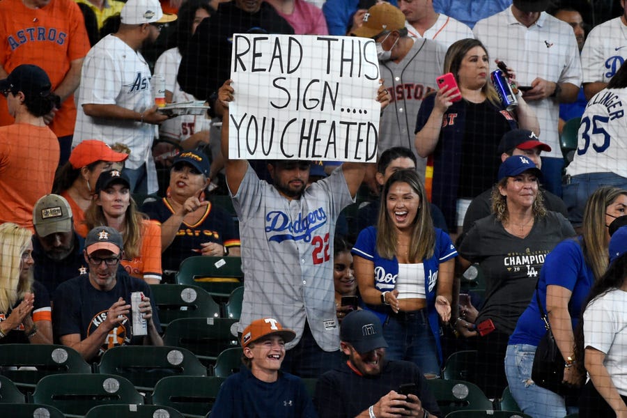 A Dodger fan holds a sign at an Astros game earlier this season in Houston.