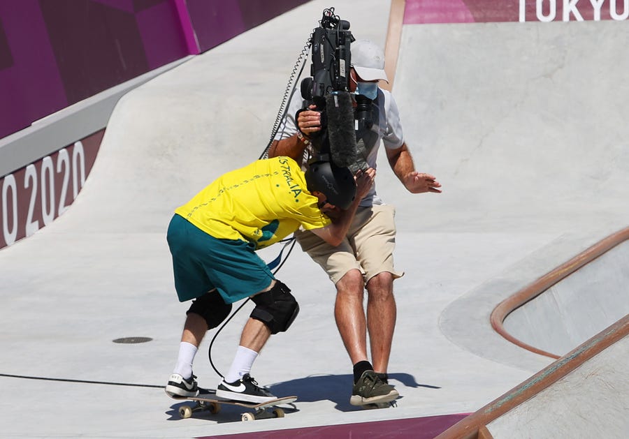 Kieran Woolley of Team Australia crashes into a TV Cameraman during the Men's Skateboarding Park Preliminary Heat 3 on day thirteen of the Tokyo 2020 Olympic Games. Australia's Kieran Woolley was finishing a big run when he went to ride a rail atop the bowl.