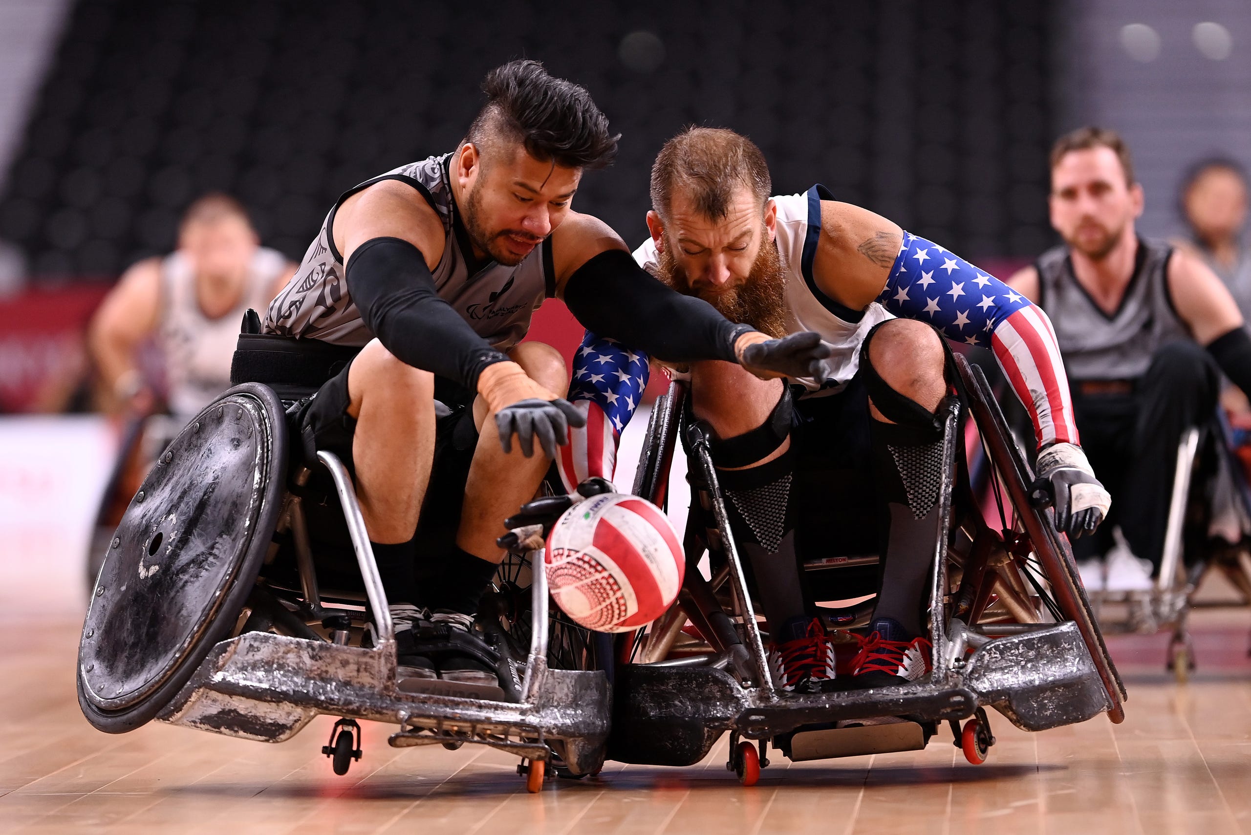 August 25, 2021: Tainafi Lefono of Team New Zealand is tackled by Charles Melton of Team United States during the Wheelchair Rugby Pool Phase Group B match between Team United States and Team New Zealand on day 1 of the Tokyo 2020 Paralympic Games at Yoyogi National Stadium in Tokyo, Japan.