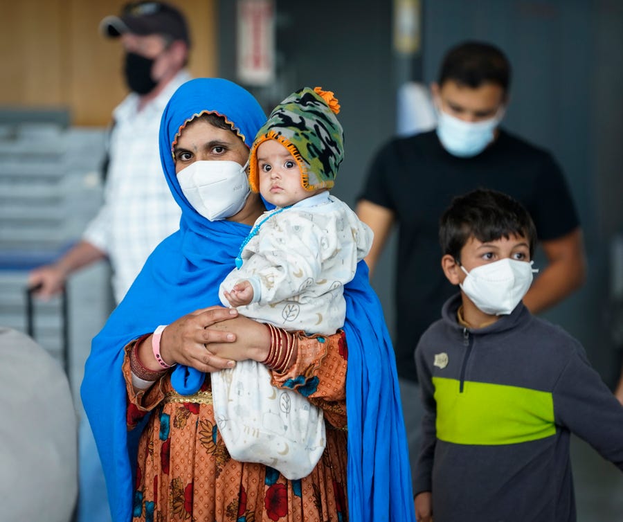 Afghan refugees arrive Aug. 26 at Dulles International Airport in Northern Virginia en route to military facilities in the USA.