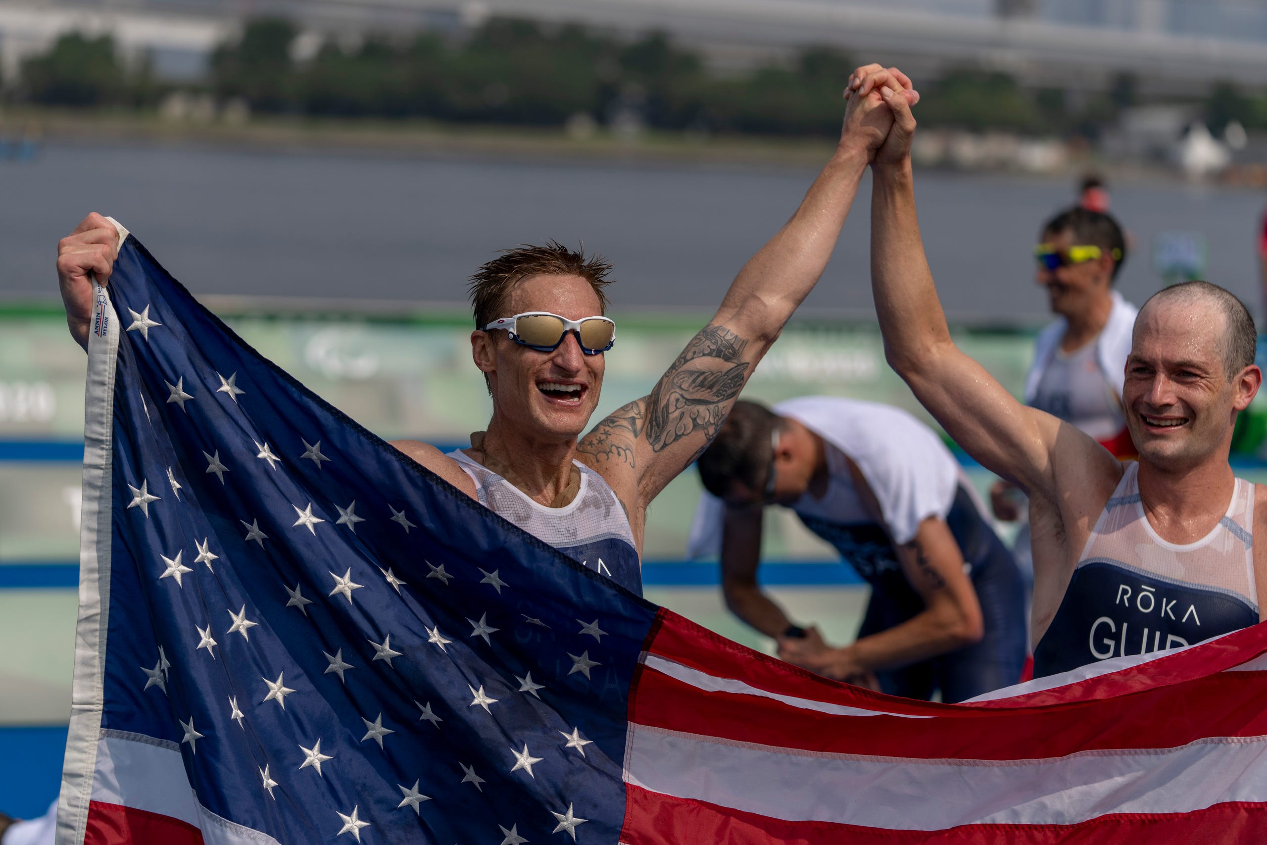 Aug. 27: Team USA's Brad Snyder and guide Greg Billington, celebrate after wining the Men's Triathlon PTV1 at the Odaiba Marine Park.