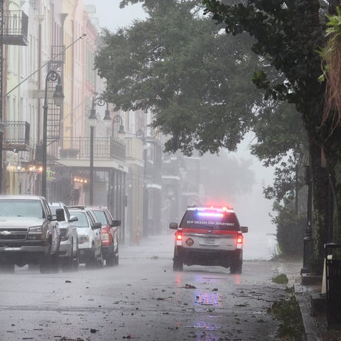 A police car cruises through the French Quarter du