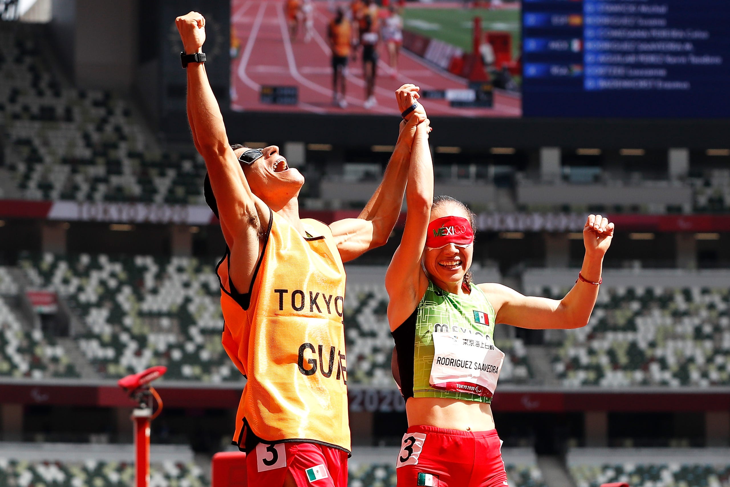 August 30, 2021: Monica Olivia Rodriguez Saavedra and guide Kevin Teodoro Aguilar Perez of Team Mexico react after winning the gold medal in the women's 1500m - T11 final on day 6 of the Tokyo 2020 Paralympic Games at Olympic Stadium in Tokyo, Japan.