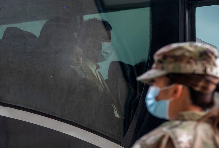 August 31, 2021: Families evacuated from Kabul, Afghanistan, sit onboard a bus after they arrived at Washington Dulles International Airport, in Chantilly, Va.