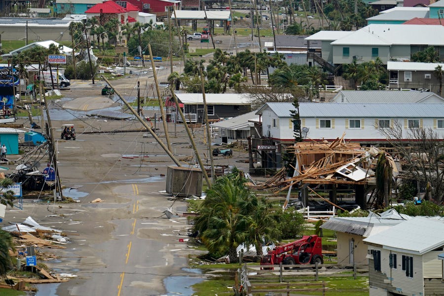 In this aerial photo from a rescue flight provided by MedicCorps.org, sand on the road from storm flooding, and destruction in Grand Isle, La. is seen in the aftermath of Hurricane Ida, Tuesday, Aug. 31, 2021.