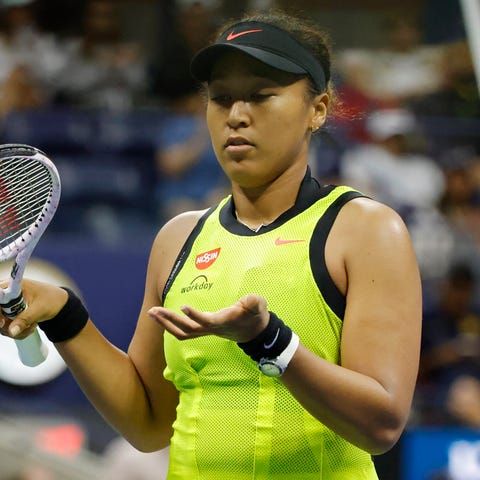 Naomi Osaka gestures after missing a shot during h