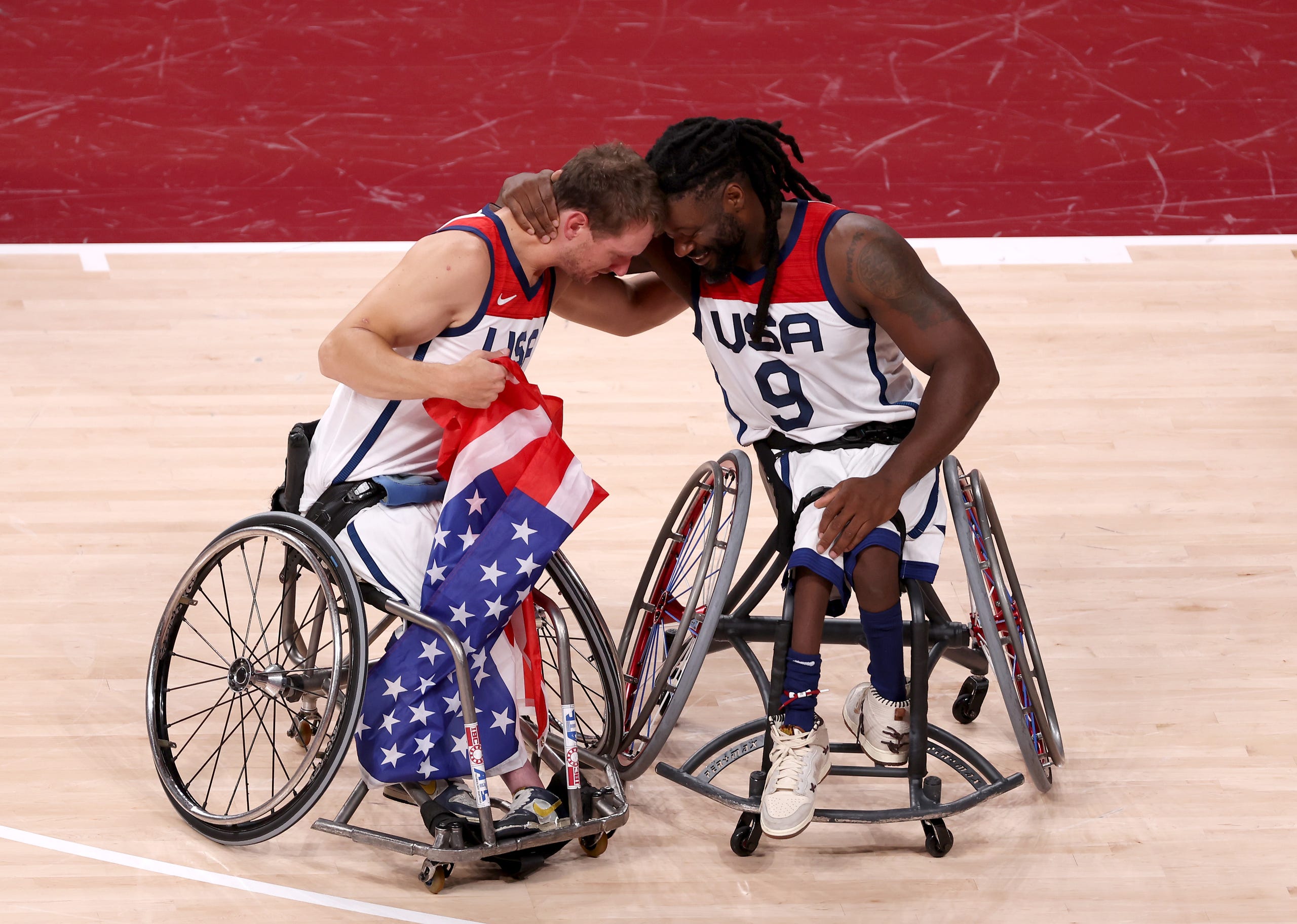 Sept. 5, 2021: Michael Paye #5 and Matt Scott #9 of Team United States celebrate after defeating Team Japan during the men's Wheelchair Basketball gold medal game on day 12 of the Tokyo 2020 Paralympic Games at Ariake Arena in Tokyo, Japan.