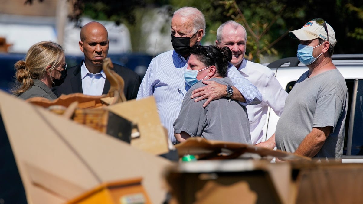 President Joe Biden tours a neighborhood hit by Hurricane Ida on Sept. 7 in Manville, N.J., accompanied by Sen. Cory Booker, D-N.J., second from left, and New Jersey Gov. Phil Murphy, second from right.