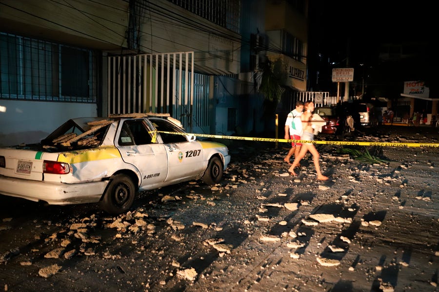 A taxi cab was damaged by falling debris after a strong earthquake in Acapulco, Mexico, on Sept. 7. The earthquake struck southern Mexico near the resort city, causing buildings to rock and sway in Mexico City nearly 200 miles away.