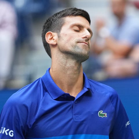 Novak Djokovic reacts to a missed shot against Dan