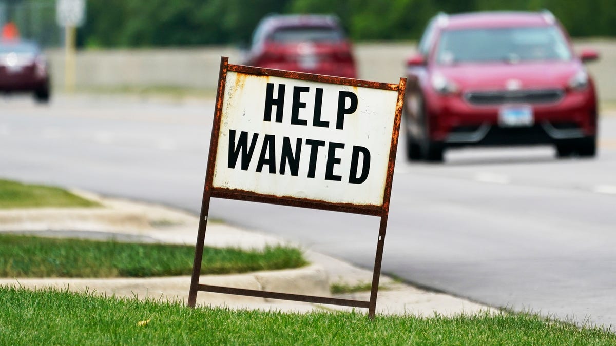 A help-wanted sign is displayed at a gas station in Mount Prospect, Ill.