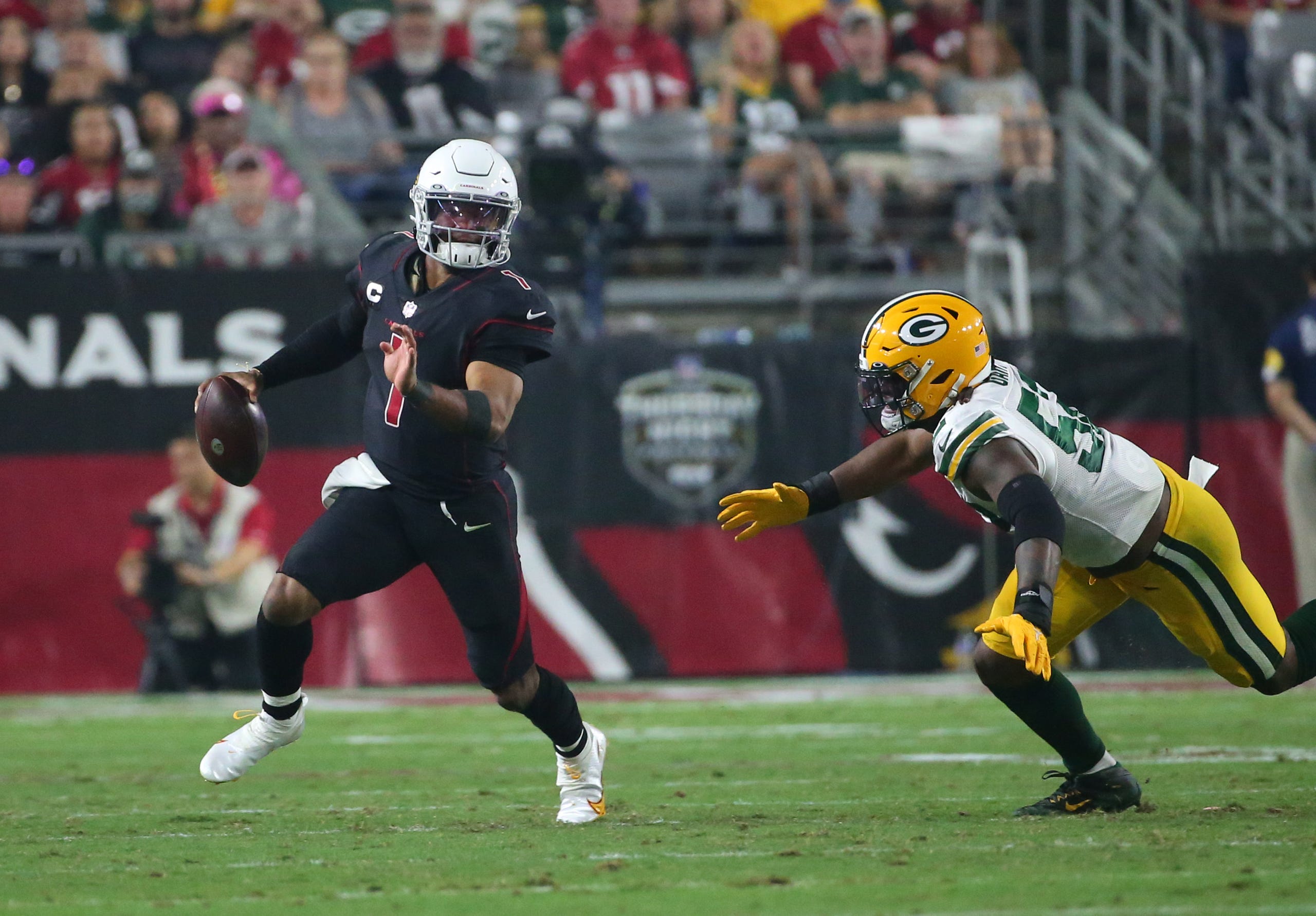 Arizona Cardinals quarterback Kyler Murray (1) scrabbles away from Green Bay Packers linebacker Rashan Gary (52) during the third quarter in Glendale, Ariz. Oct. 28, 2021.