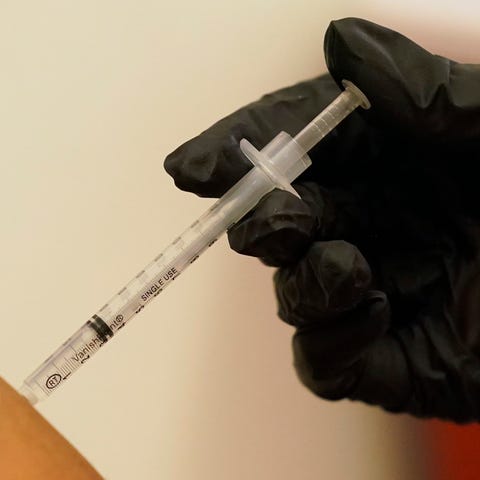 A woman is injected with her second dose of the Pf