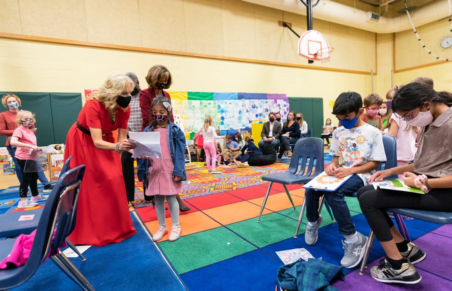 First lady Jill Biden listens to student Shaila Ramineni read her letter during a visit to a pediatric COVID-19 vaccination clinic at Franklin Sherman Elementary School in McLean, Va., on Nov. 8 to kick off a nationwide effort urging parents to vaccinate kids ages 5 to 11.