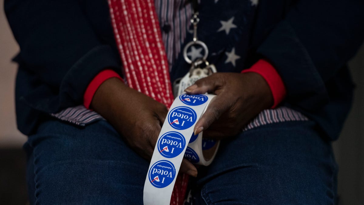 Yvonne Reader, an election official, prepares to hand out stickers to voters at Mauldin Cultural Center, in Mauldin, Tuesday, November 16, 2021. Voters hit the polls for the Seat 5 runoff on Mauldin City Council. Incumbent Dale Black faces challenger Frank Allgood, neither of whom had 50% of the vote at the Nov. 2 election.