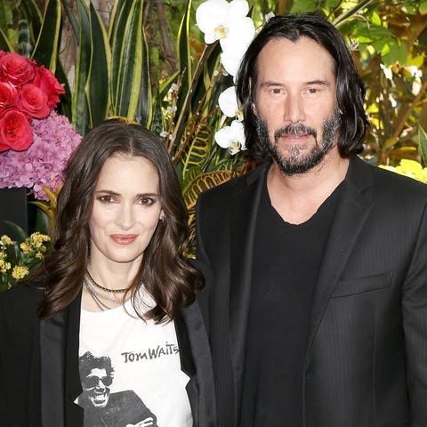 Winona Ryder, left, and Keanu Reeves attend a phot