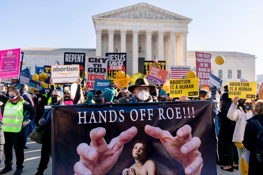 December 1, 2021: Stephen Parlato of Boulder, Colo., holds a sign that reads "Hands Off Roe!!!" as abortion rights advocates and anti-abortion protesters demonstrate in front of the U.S. Supreme Court, in Washington, as the court hears arguments in a case from Mississippi, where a 2018 law would ban abortions after 15 weeks of pregnancy, well before viability.