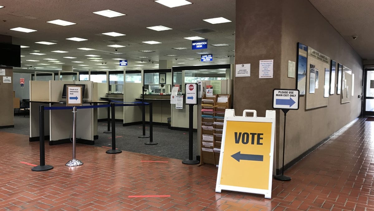 A sign in Ventura County's administrative headquarters directs voters to the county Elections Division.