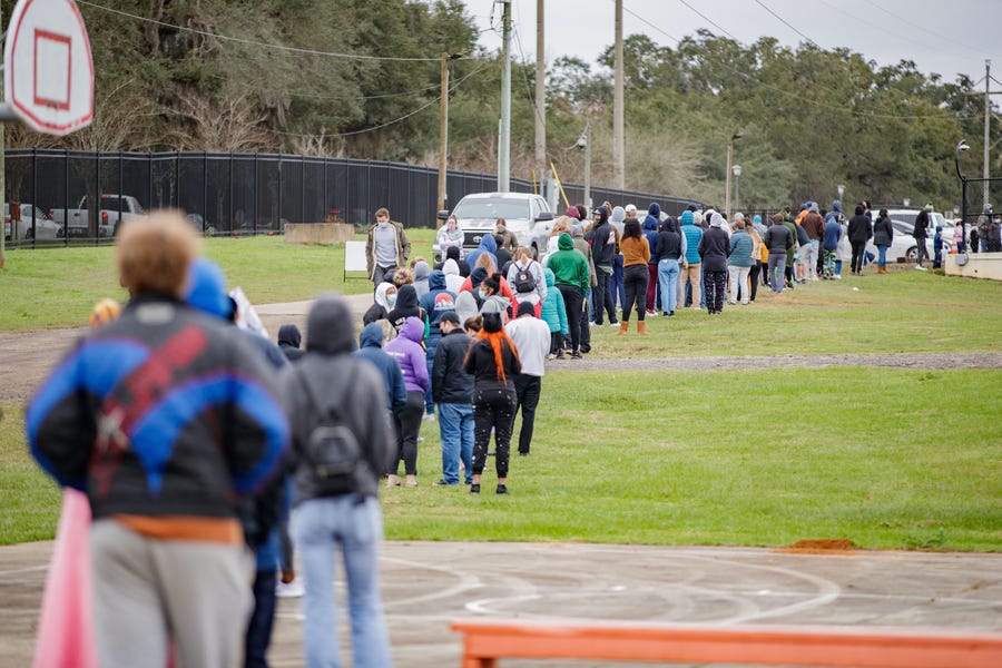 Hundreds of people wait in line to be tested for COVID-19 at the Florida A&M University testing site Monday, Jan. 3, 2022 in Tallahassee, Fla.    