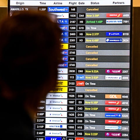 People check flight information at Miami Internati