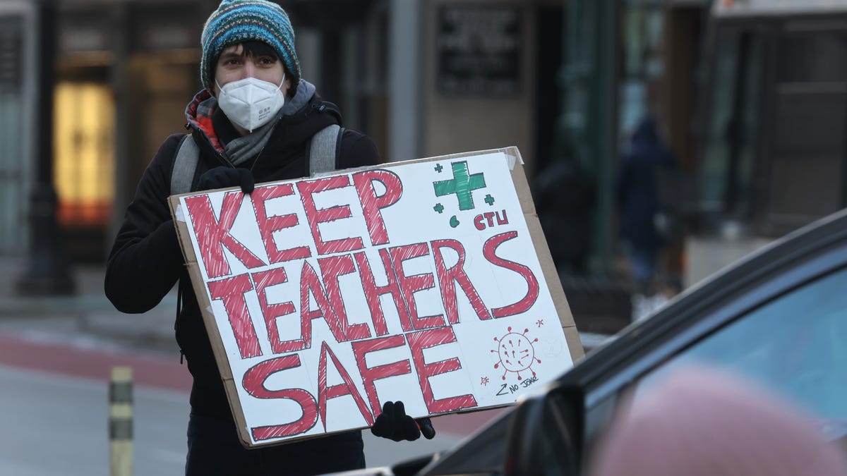 Members of the Chicago Teachers Union and their supporters participate in a car caravan around City Hall on Jan. 10, 2022, to protest against in-person learning in public schools.