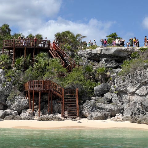 People visit the pre-Columbian Mayan archaeologica