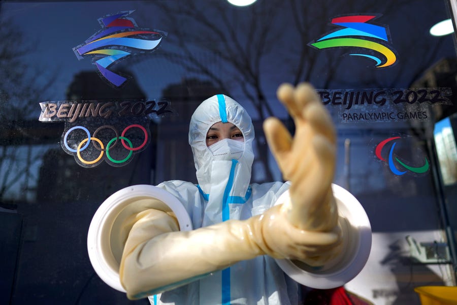 A worker prepares to administer a coronavirus test at the 2022 Winter Olympics in Beijing.