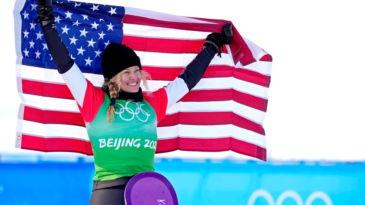 Lindsey Jacobellis celebrates winning the gold medal in the women's snowboard cross.