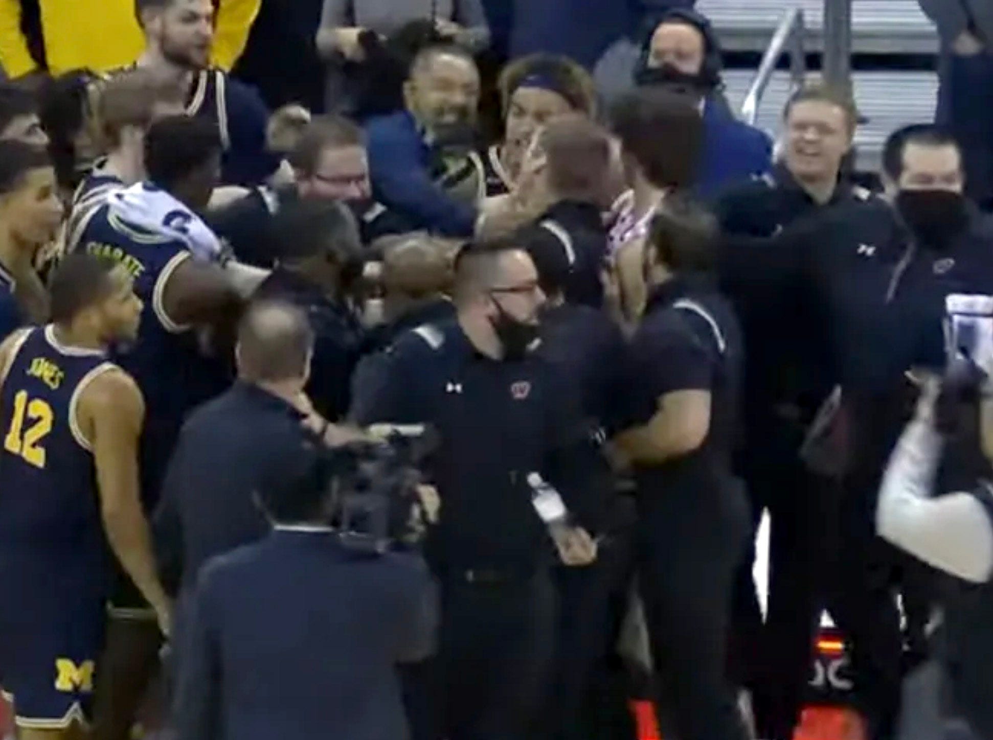 Michigan's Juwan Howard slaps Wisconsin assistant in postgame fight