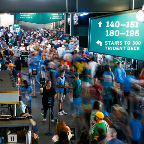 Fans walk around the lower level concourse at T-Mo