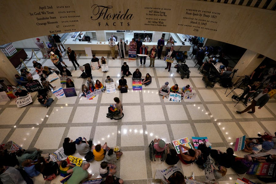 Demonstrators protest inside the Florida State Capitol, Monday, March 7, 2022, in Tallahassee, Fla. Florida House Republicans advanced a bill, dubbed by opponents as the "Don't Say Gay" bill, to forbid discussions of sexual orientation and gender identity in schools, rejecting criticism from Democrats who said the proposal demonizes LGBTQ people.