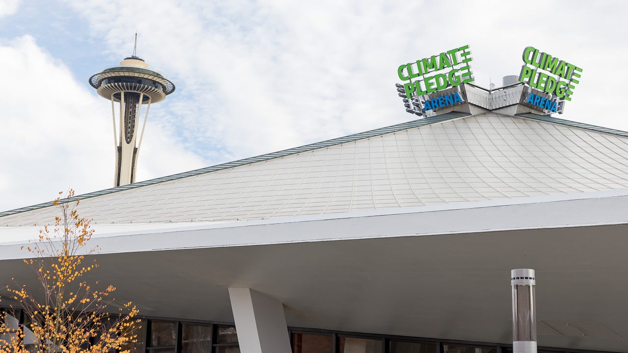 Climate Pledge Arena with the Space Needle in the background.