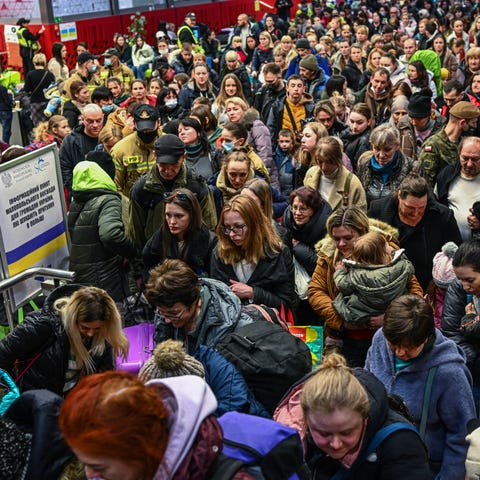 People who fled the war in Ukraine walk toward a h